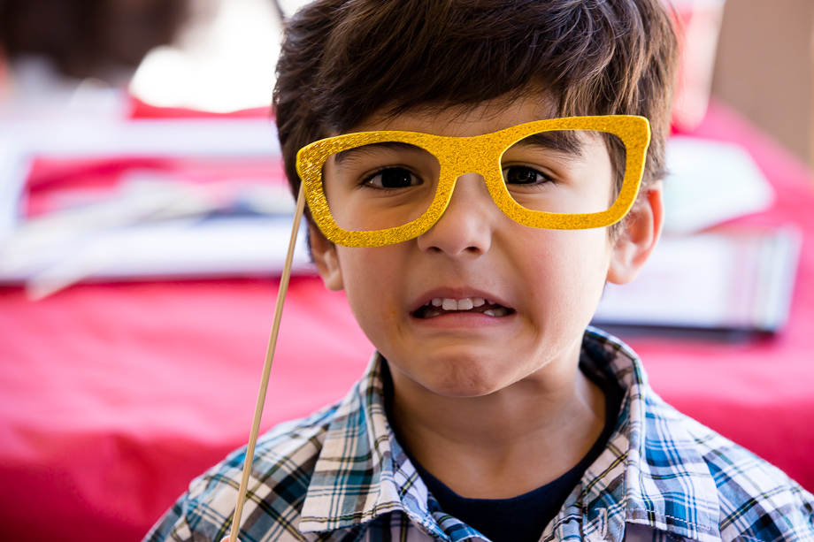 This little guest sure knows how to use some props - DIY photo booth at kids birthday party