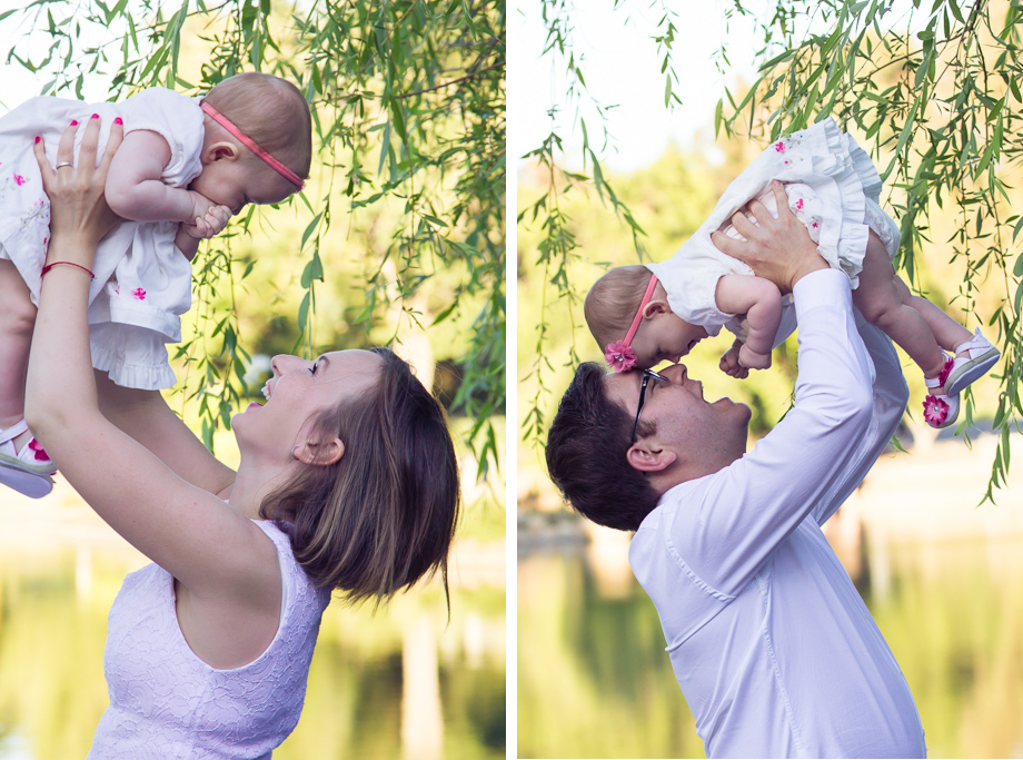 Mom and Dad holding up the 7-month-old daughter