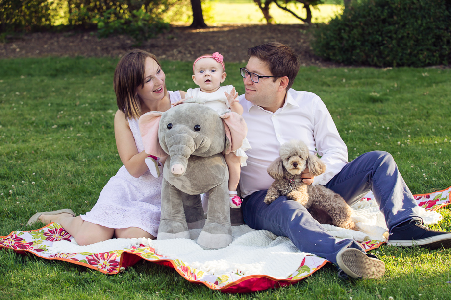 Sweet family portrait with a cute baby and a cute puppy