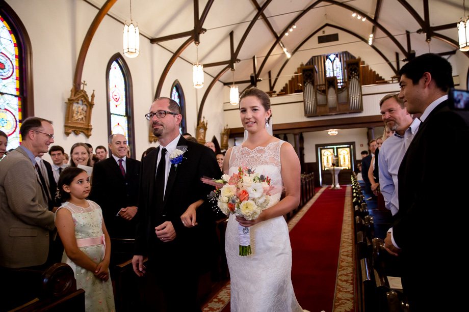 Bride and her father walking down the aisle during wedding ceremony at the Church of the Nativity