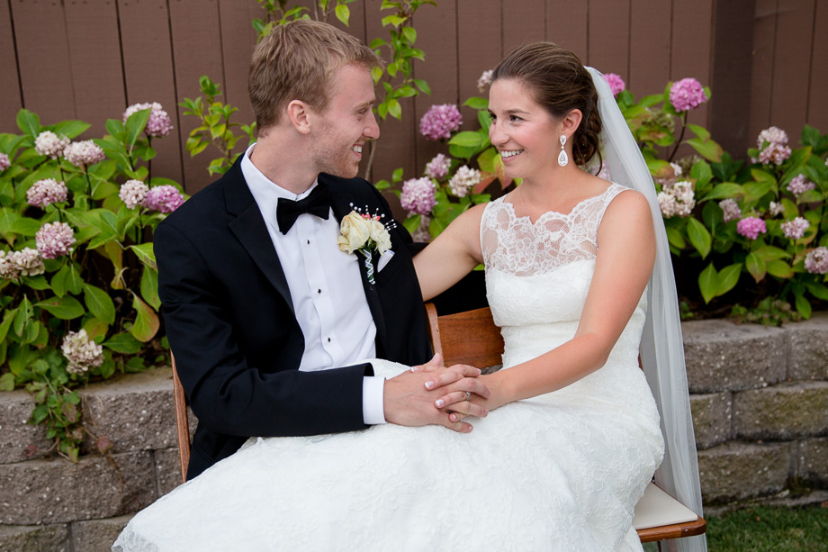 Bride sitting with her legs on the grooms lap