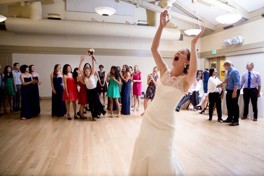 Very happy bride after tossing bouquet to an even happier girl