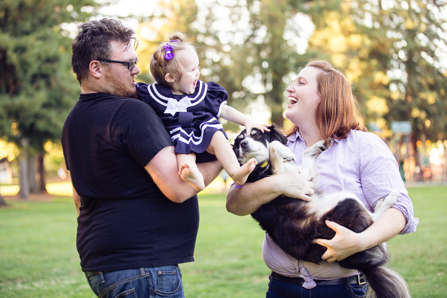 Parents holding their baby daughter and the family dog at Cuesta Park