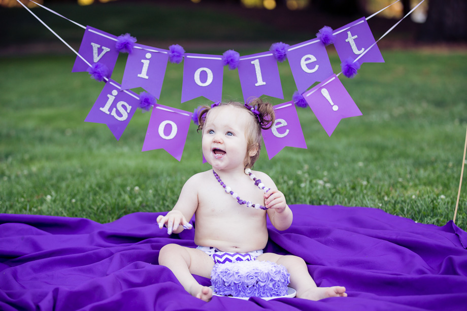 Baby Violet really enjoying the delicious birthday cake and looking excited