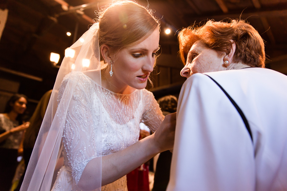 Jessica the bride is helping grandma to pin the flower