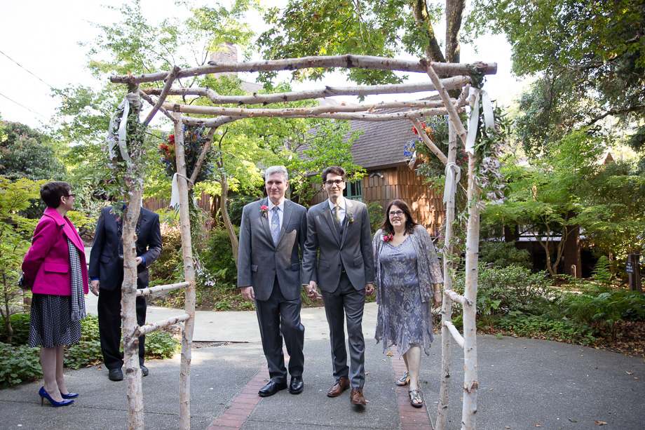 Groom and parents walking down the aisle