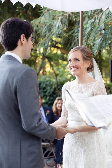 Bride and Groom join hands under a canopy