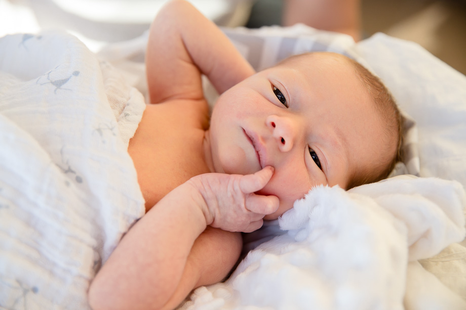 infant baby looking around in bed