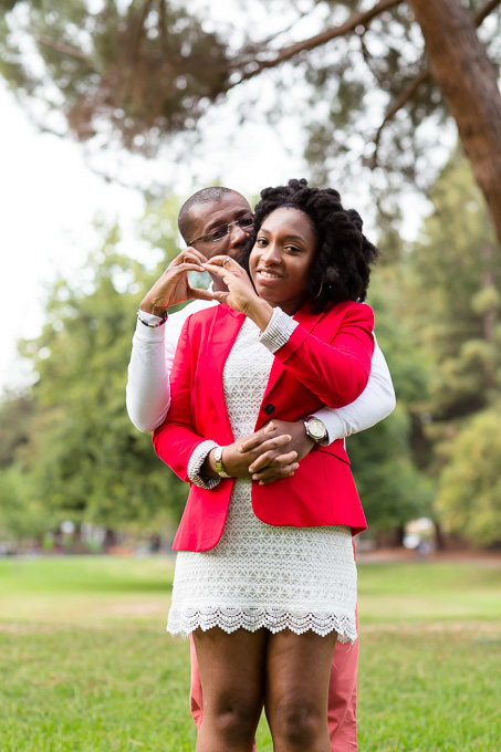 making heart shape with hands in the park