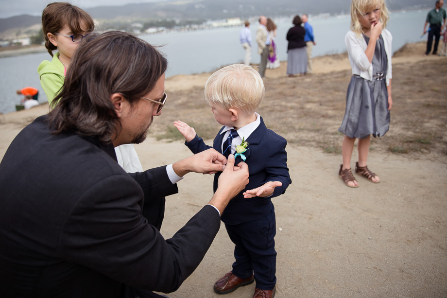 Uncle pins boutonniere for the cute little ring bearer