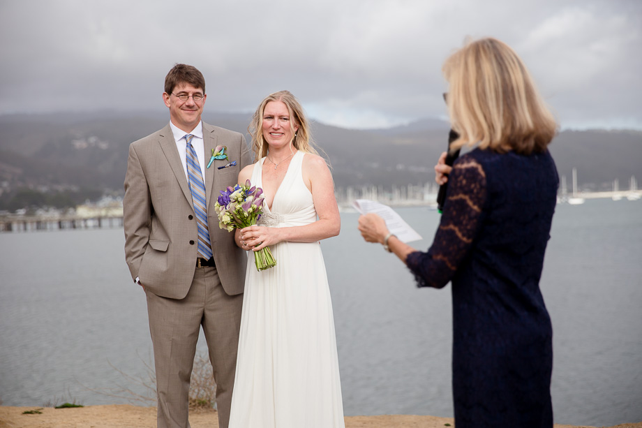 Friends and family giving blessings to the newlyweds by the sea