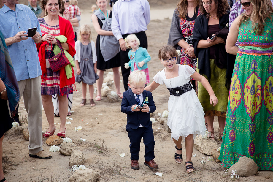 The little ring bearer is careful fulfilling his duty