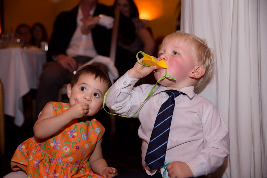 Ring bearer cheering for the toasts at reception at Mezzaluna Italian restaurant