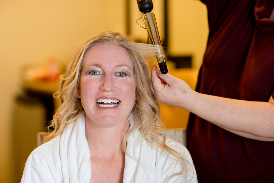 Bride getting her hair curled in Oceano hotel in Half Moon Bay