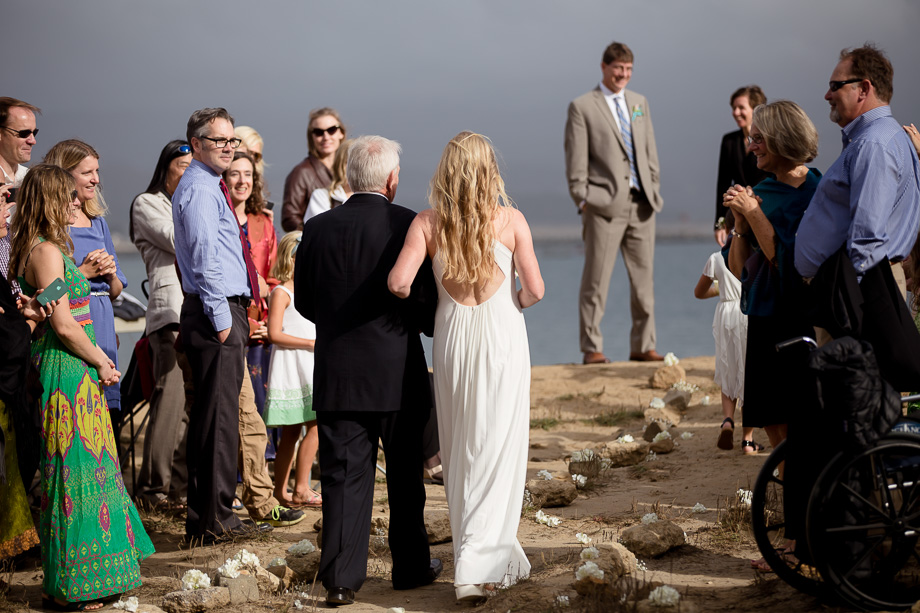 The lovely beach aisle made of rocks and white flowers