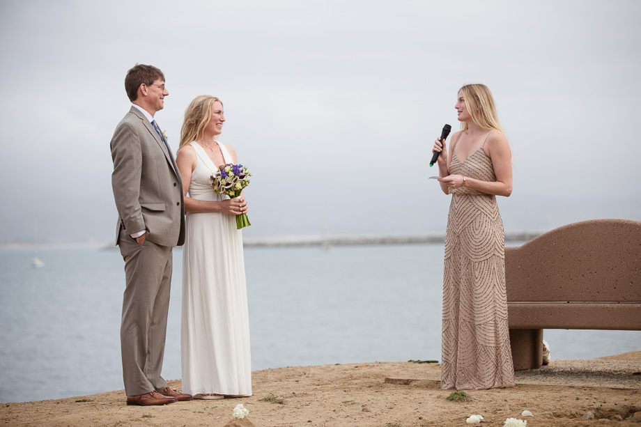 Friends and family giving blessings to the newlyweds by the sea