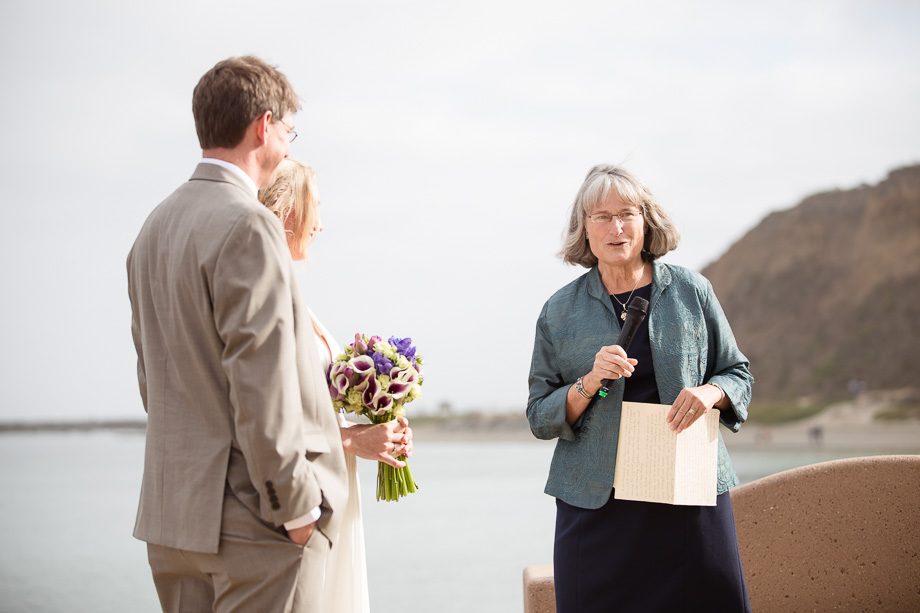 Friends and family giving blessings to the newlyweds by the sea