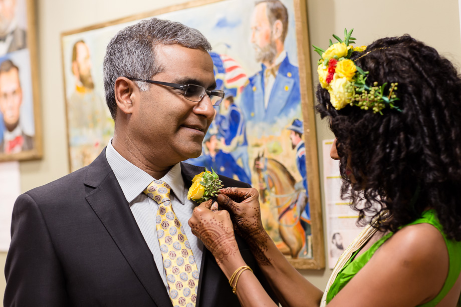 Bride pinning the boutonniere