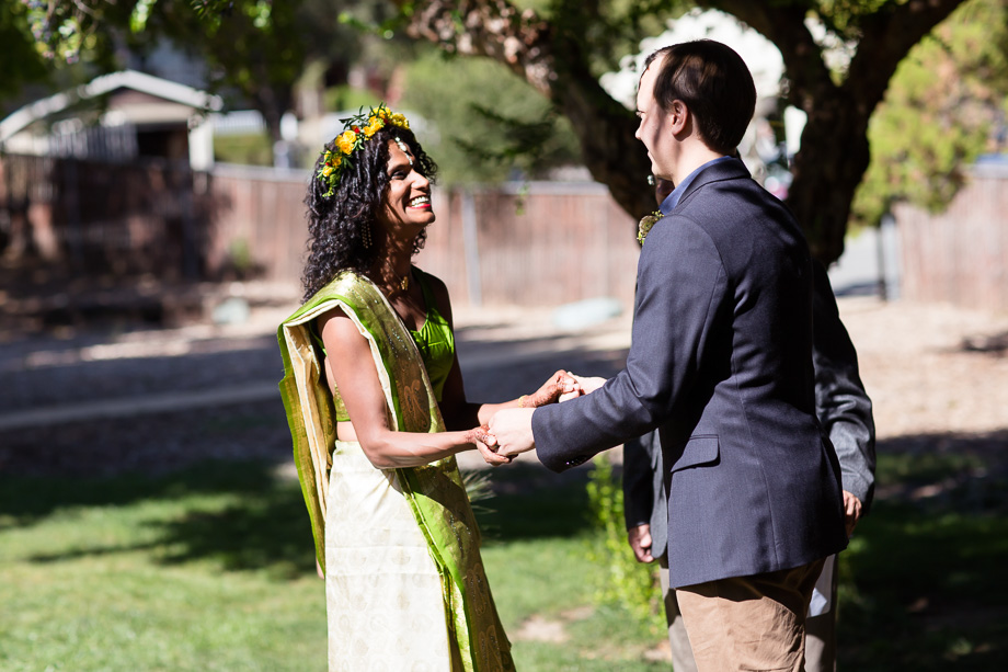 Bride and groom holding hands during wedding ceremony