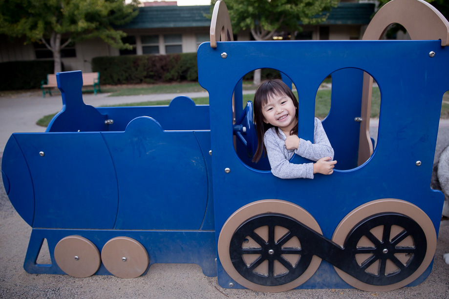 Happy girl playing in the choo choo train