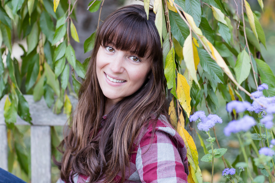Portrait of Megan in front of some fall tree leaves