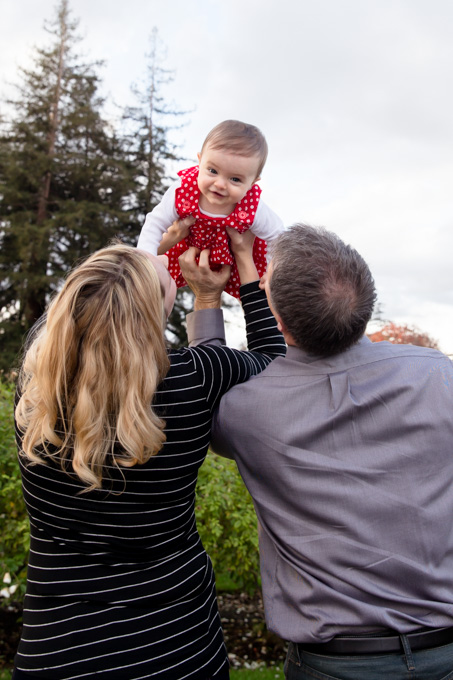 Happy giggling baby girl flying in the sky