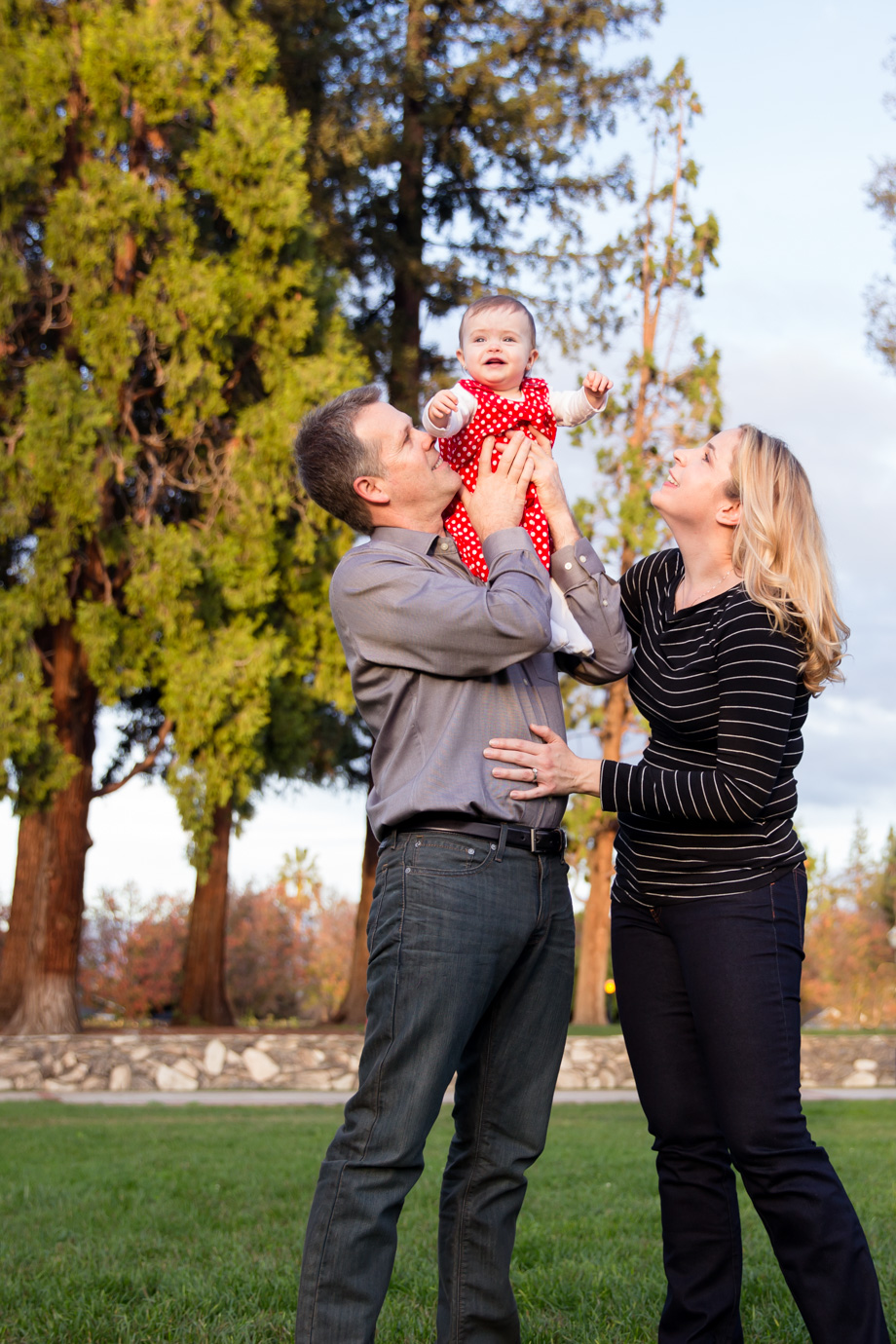 Little happy baby girl sitting on Dads shoulder