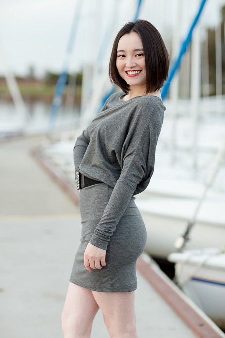 birthday girl posing in front of the boats
