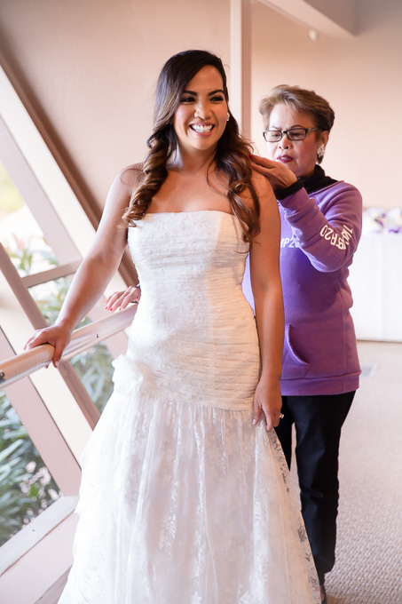 Mother of the bride helping bride get ready for wedding ceremony at Boundary Oak Golf Club