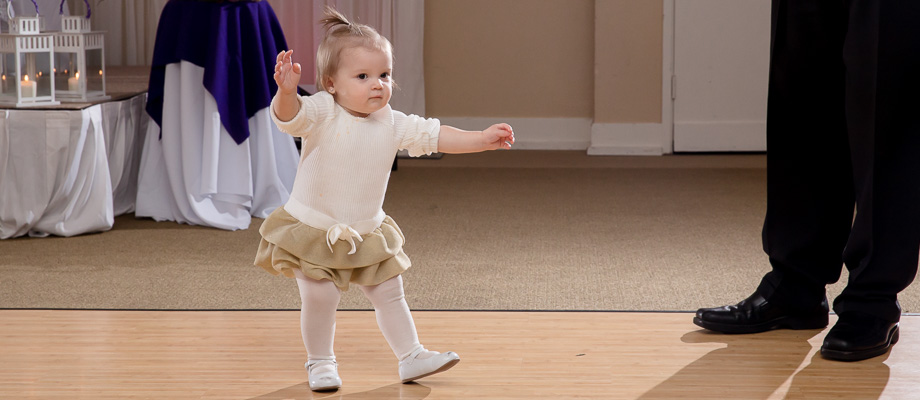 Cute baby taking a few steps and about to fall on her butt