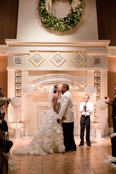Newlyweds first kiss in front of the fireplace