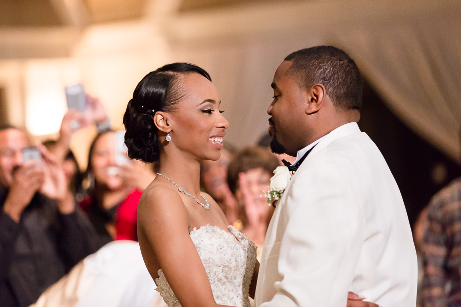 Newlyweds first dance surrounded by family and friends at the grand hall in Casa Real
