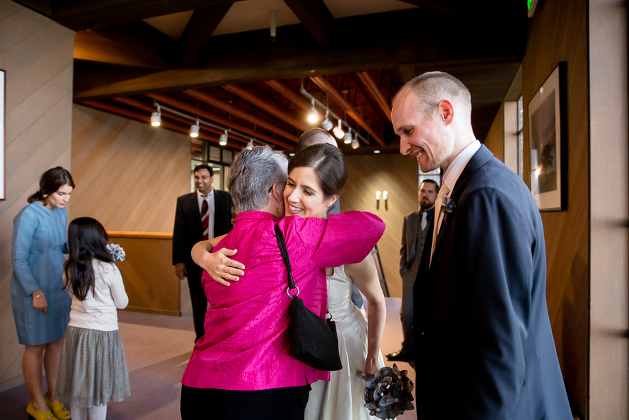 bride and groom greeting and hugging family and friends