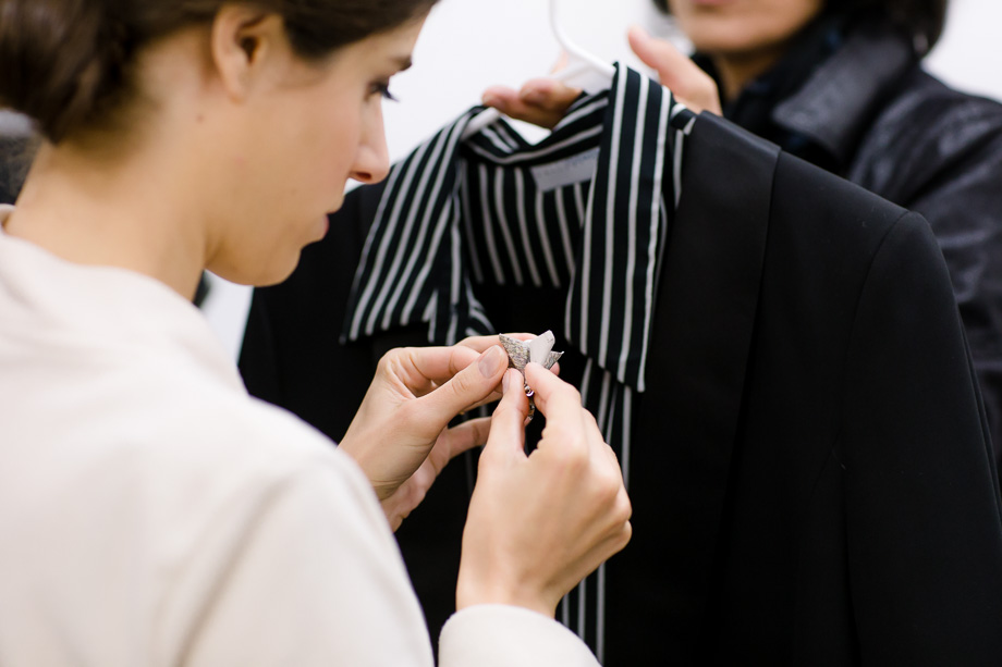Bride is pinning the DIY boutonniere