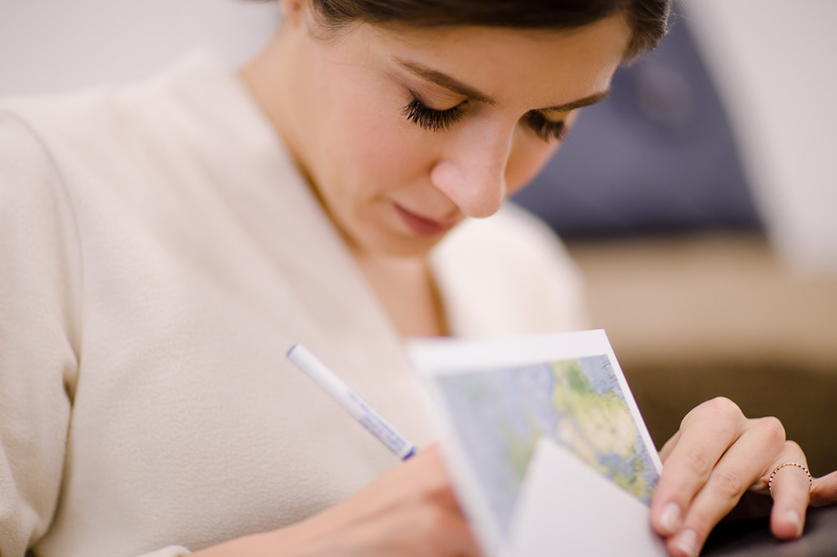 Getting ready photos at CuriOdyssey - writing a wedding card to the groom