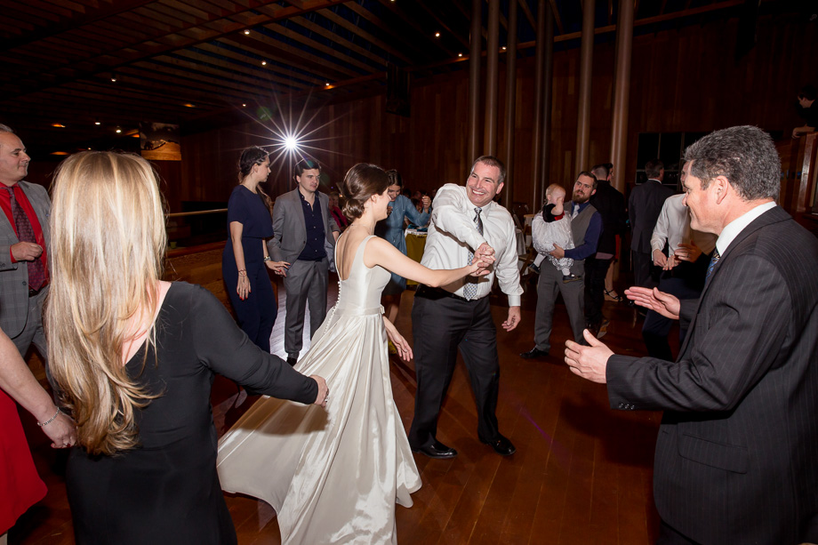 grooms father dancing with the bride at the wedding reception