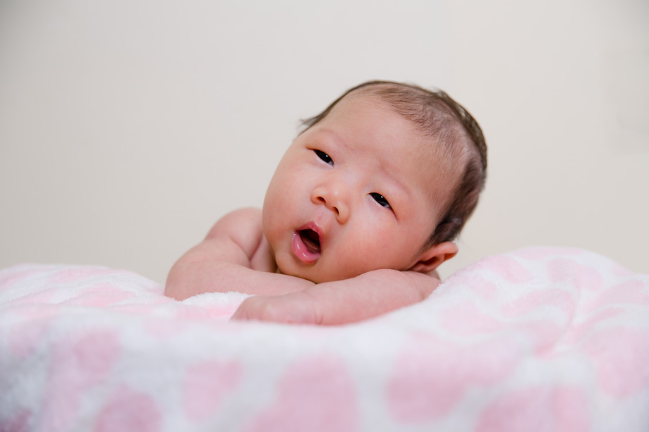 one month old girl yawning