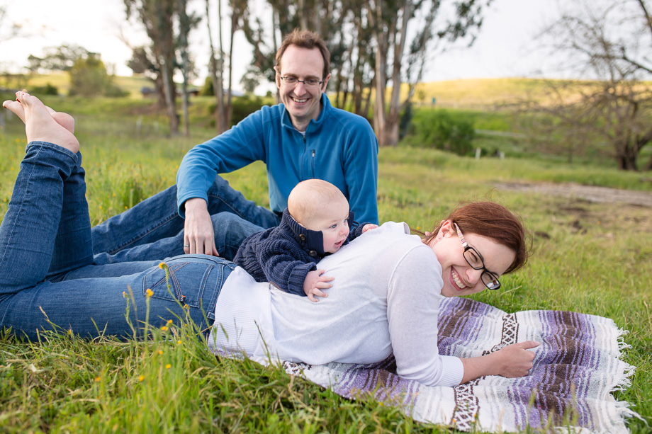 lifestyle family photo - baby boy loves pulling moms hair