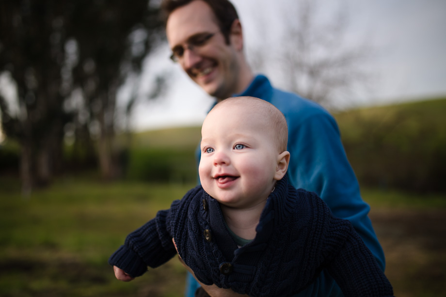 adorable little baby boy smiling in daddys arm