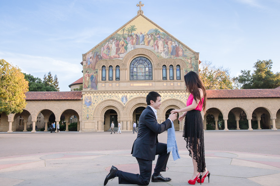 showing her the ring while on his knees for his surprise proposal