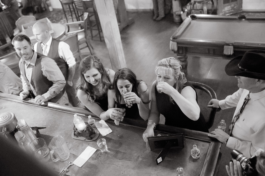 young wedding guests drinking at the wedding bar