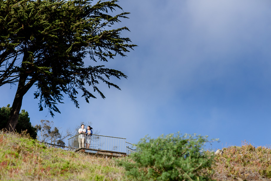 engaged couple up on a hill in the city
