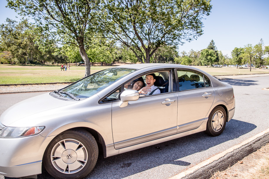 bride and groom going away in their car