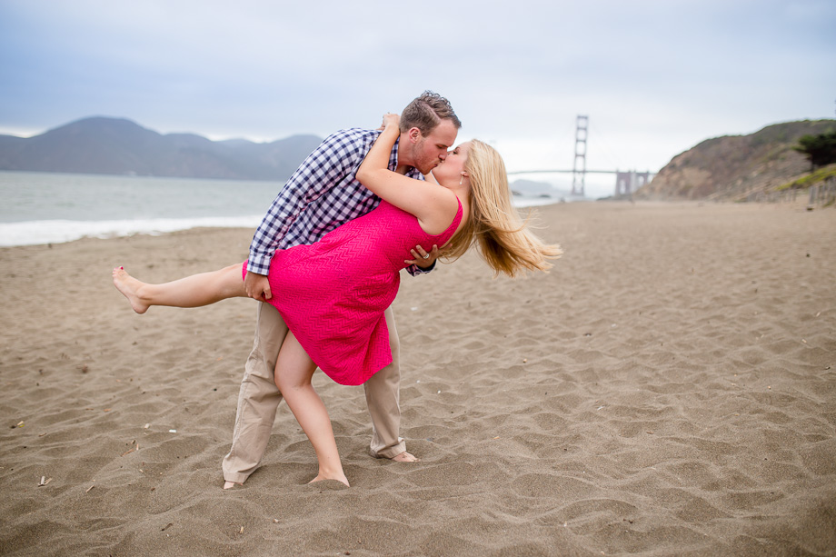 romantic dip on a quiet beach overlooking golden gate bridge
