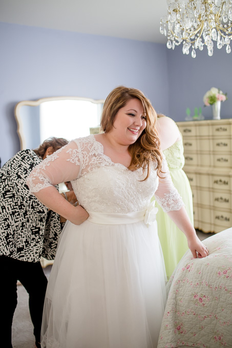 bride getting into dress