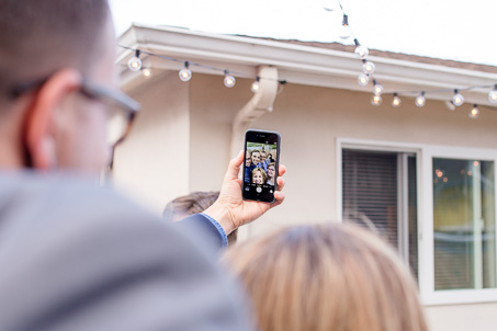 a selfie with the bride and groom and the photographer