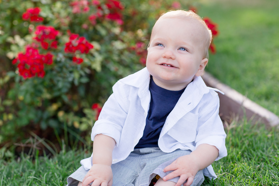 10 month old baby boy smiling at parents