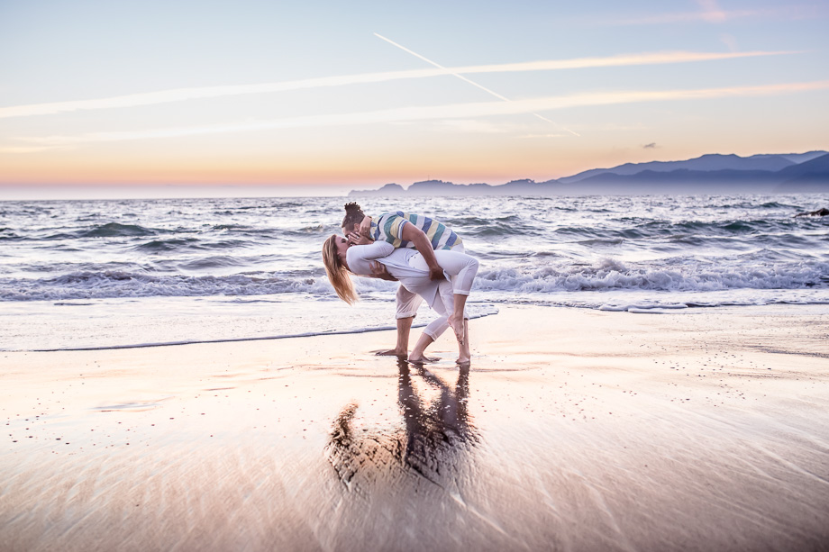 dramatic sunset engagement photo at baker beach