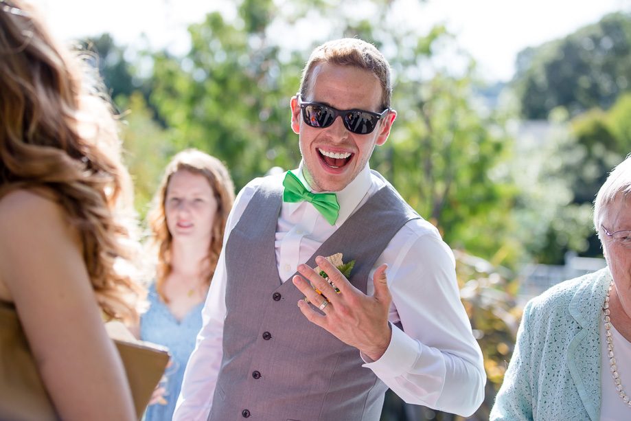 happy groom showing his wedding ring after the ceremony