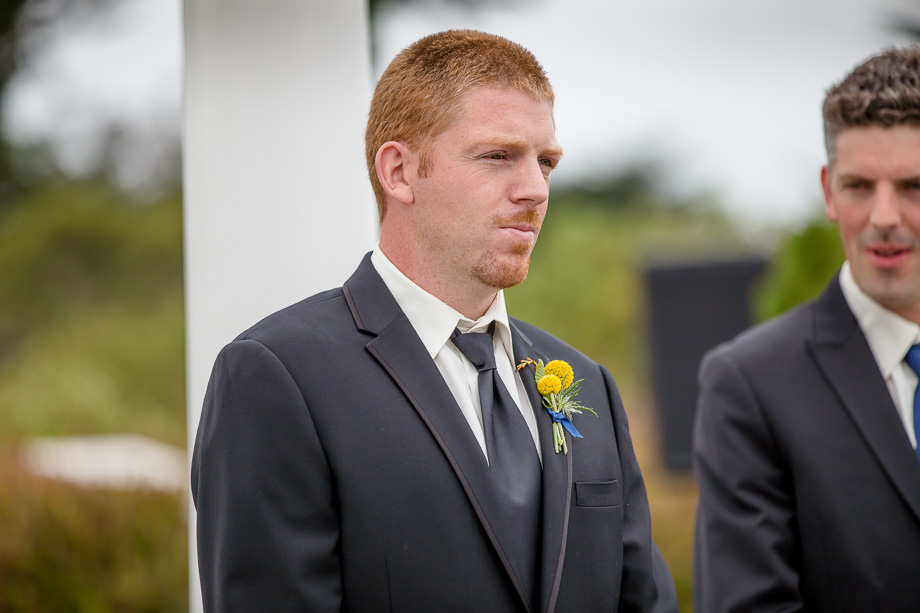 groom staring at his bride when she walks down the aisle